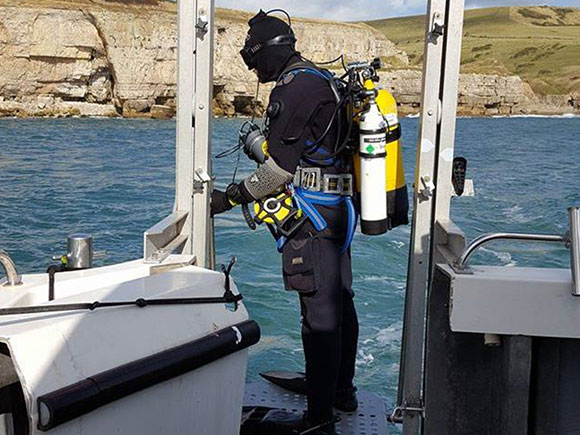 A diver on a boat getting ready